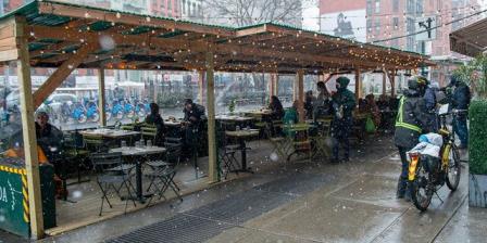 Customers dine outdoors at Jack's Wife Freda's enclosed outdoor dining structure during a snowstorm amid the coro<em></em>navirus pandemic in SoHo on Jan. 26, 2021, in New York City. The pandemic co<em></em>ntinues to burden restaurants and bars as businesses struggle to thrive with evolving government restrictions and social distancing plans made harder by inclement weather. (Alexi Rosenfeld/Getty Images)