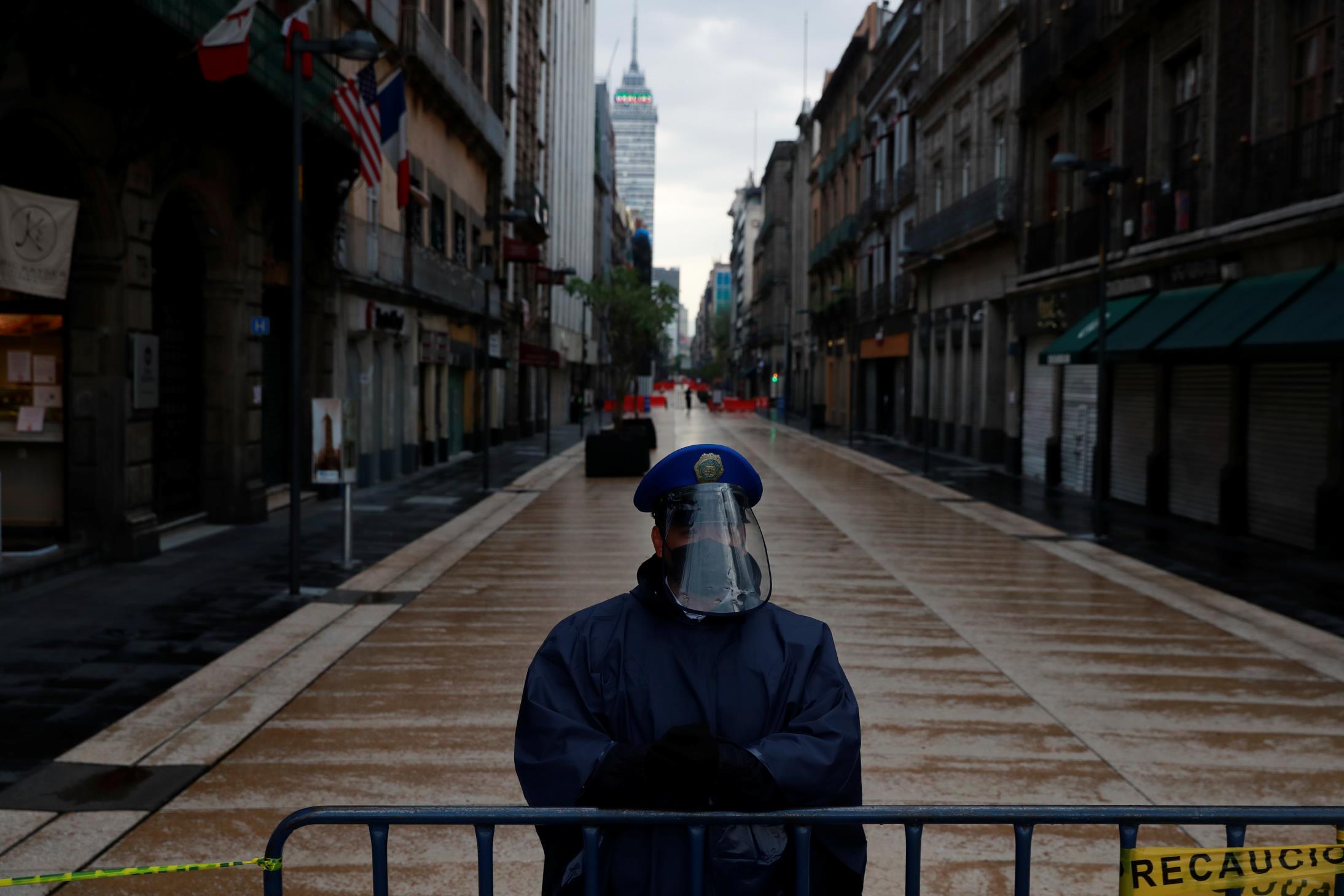 A police officer guards a closed road at the city center after amenities and businesses were shut for the second time this weekend due to overcrowding over the last few days, as the coro<em></em>navirus disease (COVID-19) outbreak continues, in Mexico City, Mexico July 4, 2020. REUTERS/Carlos Jasso
