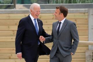 U.S.President Joe Biden and France's President Emmanuel Macron walk along the boardwalk during the G7 summit in Carbis Bay, Cornwall, Britain, June 11, 2021. REUTERS/Phil Noble/Pool  