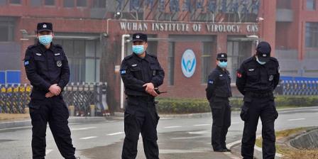 Security perso<em></em>nnel gather near the entrance of the Wuhan Institute of Virology during a visit by the World Health Organization team in Wuhan in China's Hubei province on Wednesday, Feb. 3, 2021. (AP Photo/Ng Han Guan)