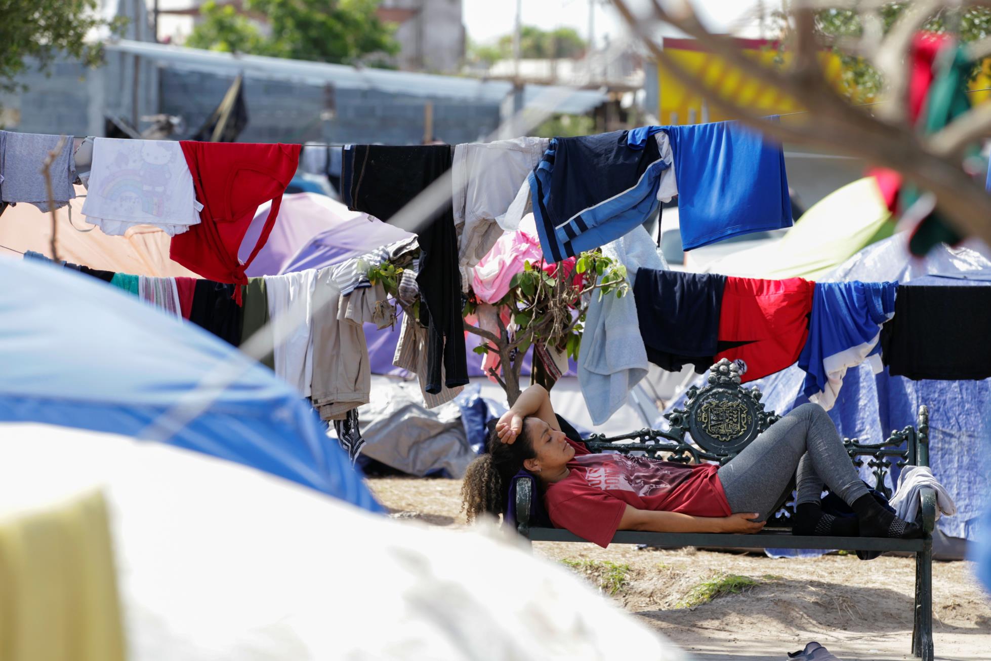 An asylum-seeking migrant, who was apprehended and returned to Mexico under Title 42 after crossing the border from Mexico into the U.S., rests in a public square wher<em></em>e hundreds of migrants live in tents, in Reynosa, Mexico June 9, 2021. Picture taken June 9, 2021. REUTERS/Daniel Becerril