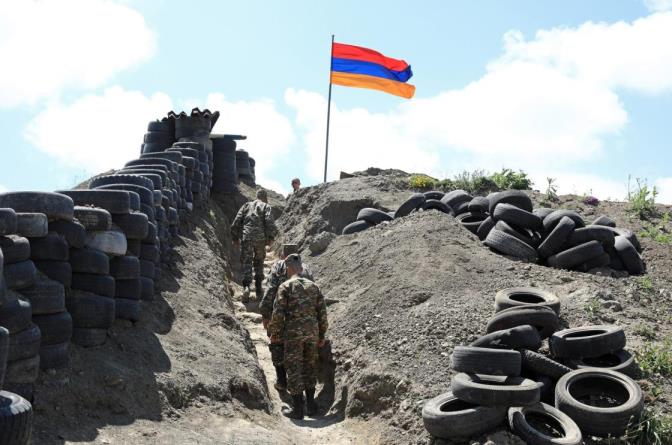 A flag over an observation post at an Armenian checkpoint at the Sotk gold mine on the border with Azerbaijan, June 18, 2021 (Reuters Photo) 