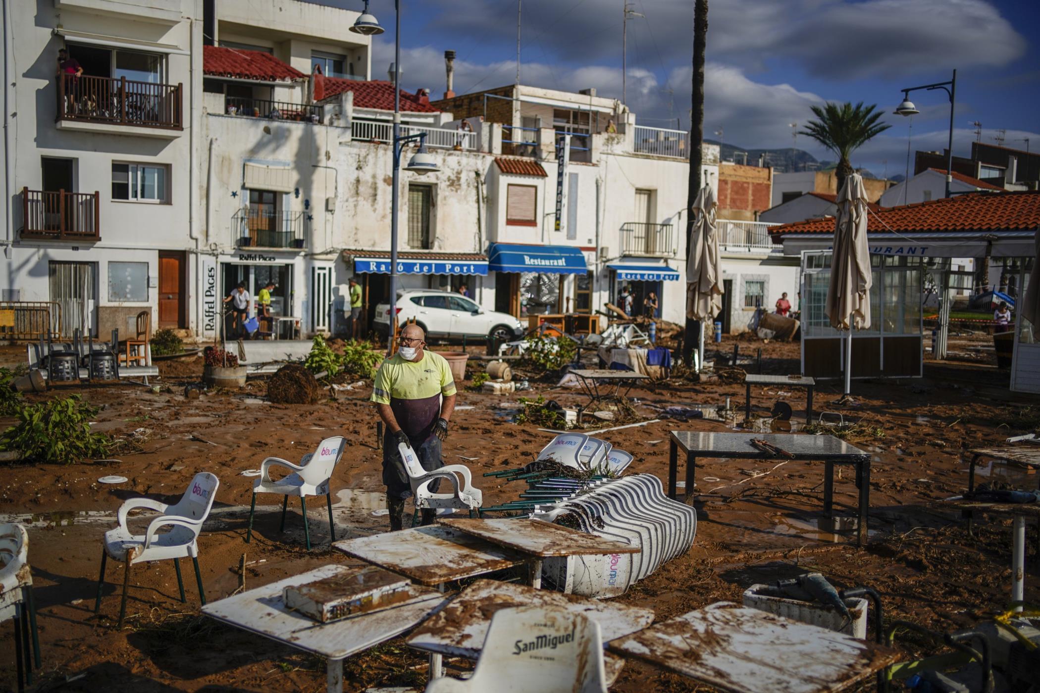 A municipality worker cleans up after flooding in a seaside town of Alcanar, in northeastern Spain, Sept. 2, 2021. (AP Photo)