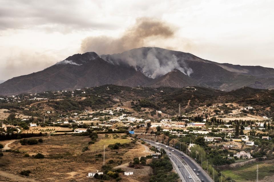 Smoke rises over smoking mountains near the town of Jubrique, in Malaga province, Spain, Sept. 13, 2021. (AP Photo)