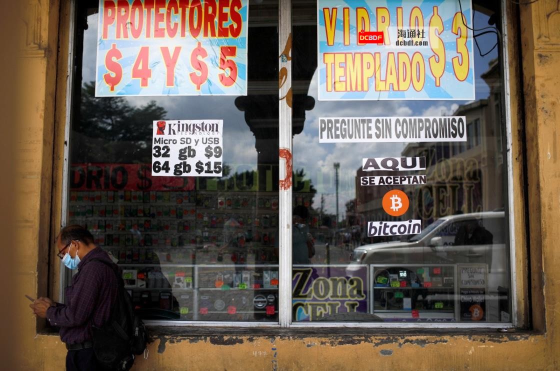 A man stands by a sign that reads, "Bitcoin accepted here," outside a store in San Salvador, El Salvador, Sept. 24, 2021. (Reuters Photo)