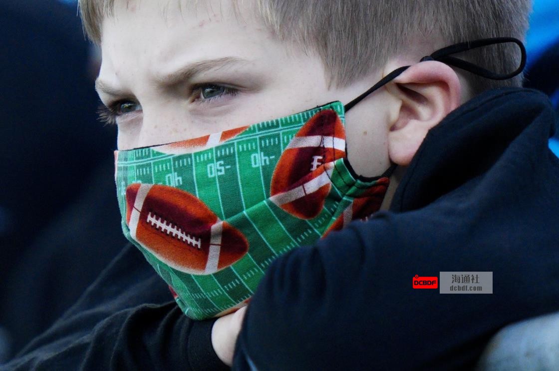 A fan wearing a football face mask watches during warm ups before an NFL football game between the Carolina Panthers and the Philadelphia Eagles, Oct. 10, 2021, in Charlotte, N.C. (AP Photo)