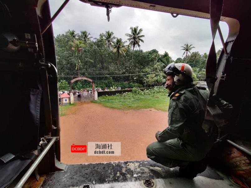 A navy person looking from their helicopter on a mission to distribute relief materials to flood-affected people at Koottickal in Kottayam district, southern Kerala state, India, Oct.17, 2021. (Indian Navy photo via AP)